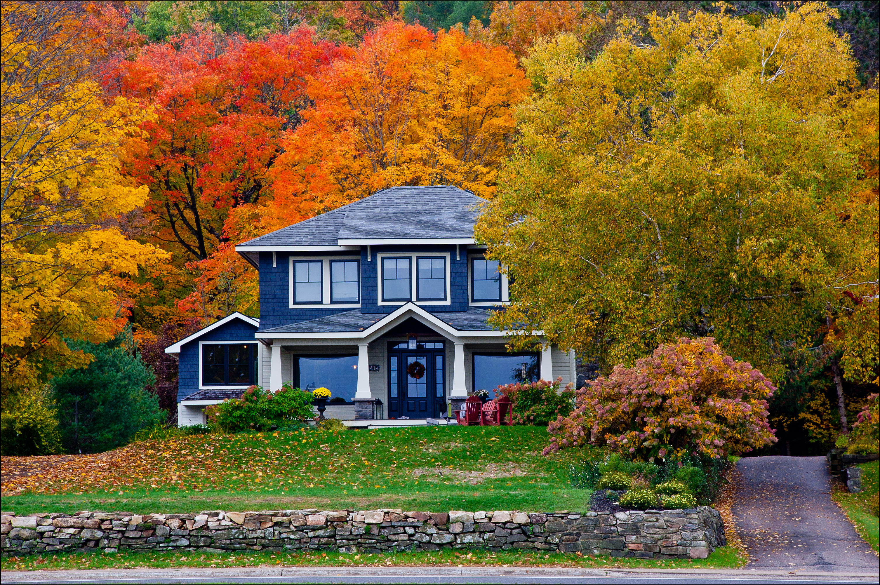 Image of 2-Story Home Surrounded by Trees Showing Fall Colors